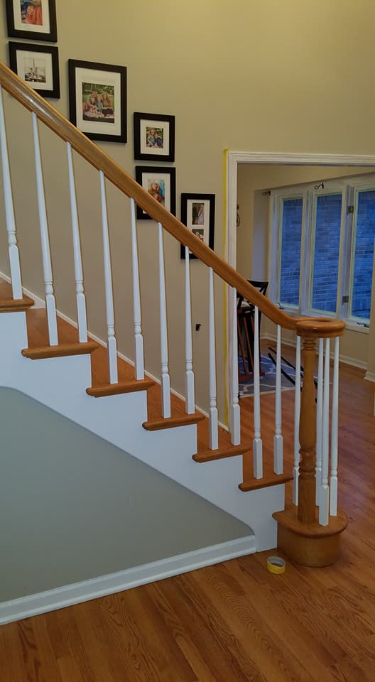 staircase inside the house with photoframes on the wall